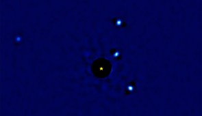 Four faint exoplanets orbit star HR8799, which is represented by a star-shaped icon in the center. (The star itself was removed from the video because its glare is so intense that it blocks out the surrounding planets.)