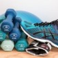 A photo of blue dumbbells and blue running shoes.