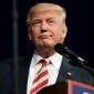 Donald Trump stands in front of a microphone