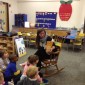 In this 2014 file photo, kindergarten teacher Mary Elizabeth Duffy reads a story to her class at Seventh Avenue School in La Grange. A bill in Springfield would lower the kindergarten age to 5. | Jane Michaels/Sun-Times Media file photo