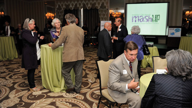 A group of people networking at the fourth annual MashUp conference