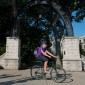 A cyclist rides a bike at Weber Arch on Northwestern's campus. 