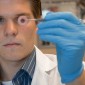 Student looking at a sample in the lab.