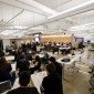 A view of the main collaboration area in The Garage, Northwestern's hub for student innovation. It is packed with students.