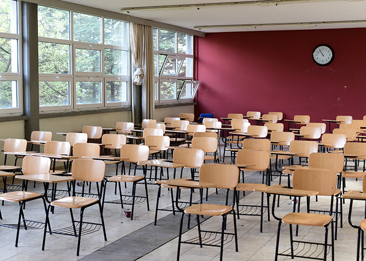 A photo illustration showing empty seats in a classroom
