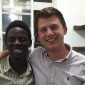 Northwestern senior Isaac Rappoport, who visited Uganda in summer 2015, has his arm around an Ugandan boy.
