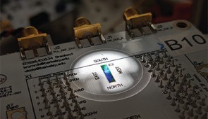 Packaged circuit board containing the chip placed under microscope in probe station during an experiment.