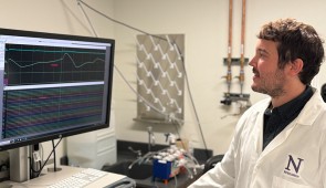 Corresponding study author Andrew Sheriff looks at a monitor examining brain waves of someone as they breathe in and out.