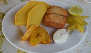 Breadfruit served for breakfast, alongside starfruit and plantains.
