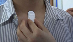A close-up of the respiratory-monitoring device, placed on the neck of a volunteer.
