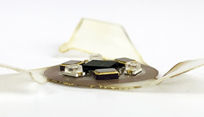 Side view of a microflier with coil antenna and sensors.