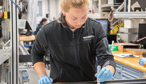 Gabriella Kitch takes samples from sediment cores in the lab.