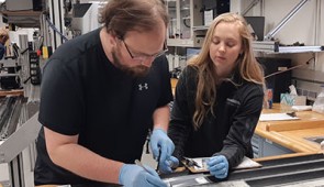 Gabriella Kitch works with a collaborator to remove samples from a sediment core.