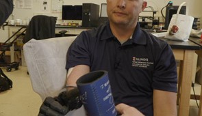 Wearing the epidermal VR patch, retired U.S. Army Sgt. Garrett Anderson reaches for an object with his prosthetic arm.