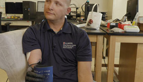 Wearing the epidermal VR patch, retired U.S. Army Sgt. Garrett Anderson tightly grips an object.