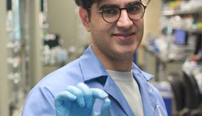 Hossein Zargartalebi, the study's first author, holds the microdevice in the lab at Northwestern.