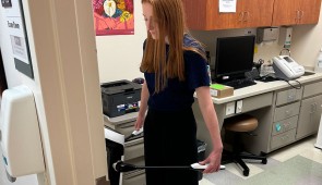 A study participant stands on the InBody machine to take measurements.