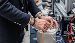 Professor Rotta Loria adjusts the electrodes in a sand sample in his laboratory.