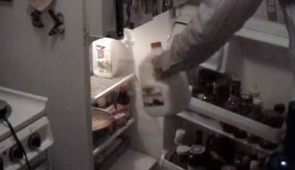 Someone puts milk in the refrigerator.