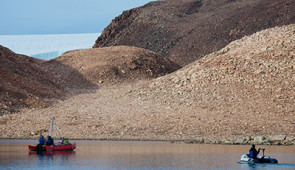 A 2014 field photo from Wax Lips Lake on northwest Greenland with the Greenland Ice Sheet in the background and three of the study authors (Jamie McFarlin, Everett Lasher, Yarrow Axford). Credit: Alex P. Taylor