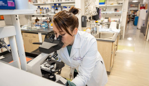 Dr. Tamar Gefen examines a slide of a SuperAger brain. (Credit: Shane Collins, Northwestern University)