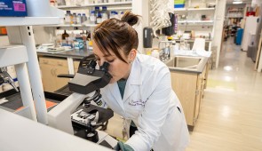 Dr. Tamar Gefen examines a slide of a SuperAger brain. (Credit: Shane Collins, Northwestern University)