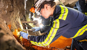 Prof. Magdalena Osburn removes a sample during a site visit in August.