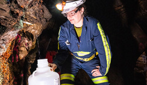 researcher collects fluids in goldmine