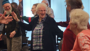 Warm-up stretches and vocal exercises during a Good Memories rehearsal.