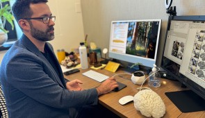 Senior author Rodrigo Braga sits at his desk.