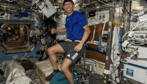 NASA astronaut Chris Williams pedals on the exercise cycle inside the International Space Station’s Destiny laboratory module.