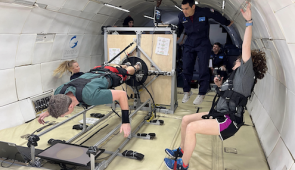 A multidisciplinary NASA team collaborates during a parabolic flight to evaluate an advanced exercise countermeasure device.