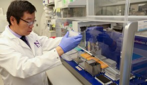 Xinkun Wang, research associate professor of biochemistry and molecular genetics and director of the NUSeq Core Facility in the Center for Genetic Medicine, in his lab in this 2018 file photo. Wang in March 2020 transformed his lab to help increase COVID-19 testing capacity in cooperation with Northwestern Medicine hospitals. (Photo credit: Teresa Crawford, Northwestern University)