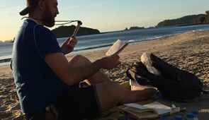 Ph.D. candidate Matthew Verosloff sits on a beach in Costa Rica during his field research trip.