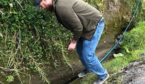 Ph.D. candidate Matthew Verosloff samples water from a ditch in Costa Rica.