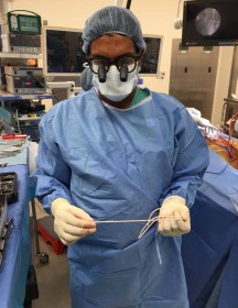 Dr. Ayer holds shunt in operating room