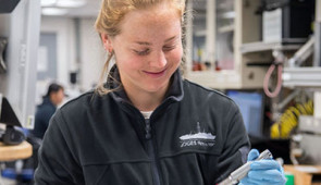 Gabriella Kitch working with sediment samples in the lab.