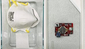 VeriMask sensor node attached to the lid of a Pyrex container along with the N95 mask and damp paper towel.