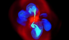 A still image taken from the 3D simulation of the natural development of an X-shaped jet. The gas (bright red) falls into the black hole, which launches a pair of relativistic jets (light blue). The jets propagate vertically and shock the ambient gas (dark red) The older cavities (dark blue) buoyantly rise at an angle to the vertically propagating jets to form the X-shape.