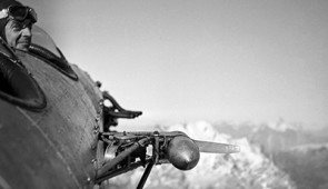 A pilot looks out of an open-cockpit airplane. Credit: The Danish Agency for Datasupply and Infrastructure