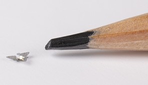 A 3D microflier next to a pencil tip for scale