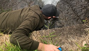 Ph.D. candidate Matthew Verosloff samples water from a river in Costa Rica.
