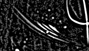 Close-up image of curved filaments resembling Saturn's rings.