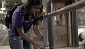 Anjali Naidu Thota, a Ph.D. student in Rotta Loria's lab, affixes a temperature sensor to a pipe in a basement beneath the Chicago Loop.