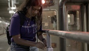 Anjali Naidu Thota, a Ph.D. student in Rotta Loria's lab, affixes a temperature sensor to a pipe in a basement beneath the Chicago Loop.