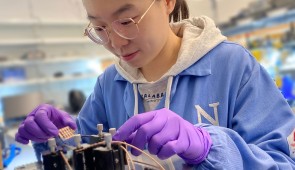 Yi Yang, the study's first author, tests a sample of the new solar cell in the lab.