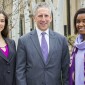 Two young women and a man pose for a picture.