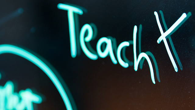 TEACHx logo in neon blue