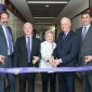 A group photo of a ribbon cutting.