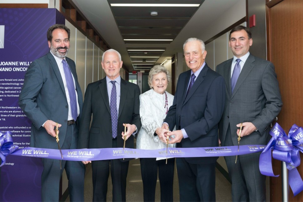 A group photo of a ribbon cutting.